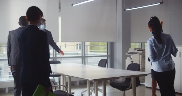International Team of Business Colleagues in Protective Masks Working Together in Office Boardroom alt