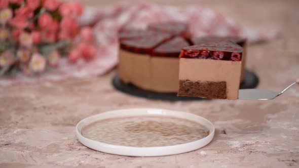 Piece of Delicious Chocolate Mousse Cake with Cherry Jelly on Top