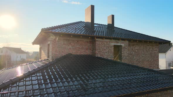 Closeup Snow Guard for Safety in Winter on House Roof Top Covered with Ceramic Shingles alt