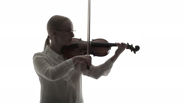 Woman Musician in a Shirt Plays the Violin with a Bow in Studio on White Background alt