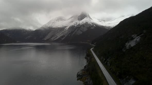 Majestic snow-covered Stetind mountain next to Tysfjord; drone flight alt
