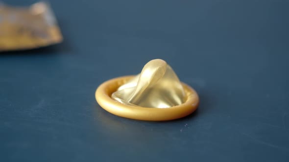 Close Up of Condom on Dark Backgrund  alt