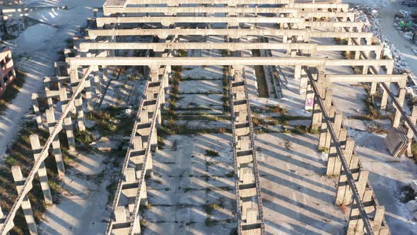 Abandoned construction of an industrial hall for a factory - concrete studs joists, columns, posts. alt