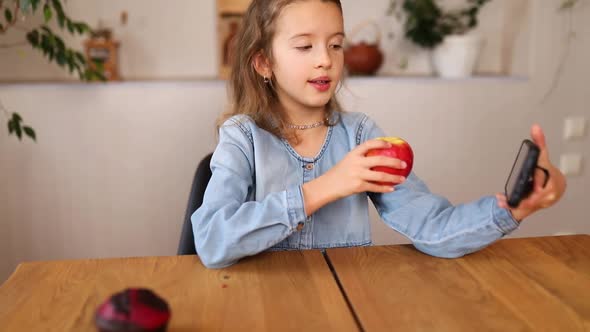 Beautiful Young Girl Filming Her Blog Broadcast About Healthy Food at the Home