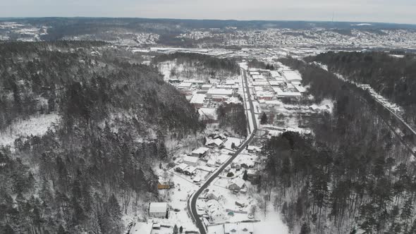 Snow Covered Villa Neighborhood in Valley Residential Area and Forest Aerial