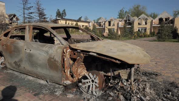 A Burnt Car and Destroyed Houses As a Result of Artillery or Rocket Fire By the Russian Army in the alt