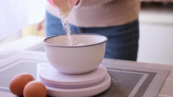 Dough Preparation  Woman Cook Pours Flour to Ceramic Bowl on Kitchen Scales alt