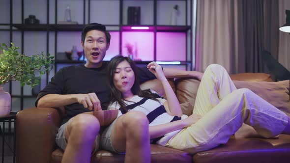 marry adult asian watching TV at home ,asian couple cheering sport games competition alt