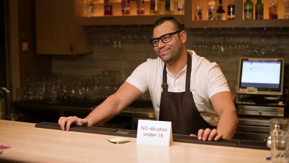 The bartender refuses a drink to a young man who is under eighteen years old alt