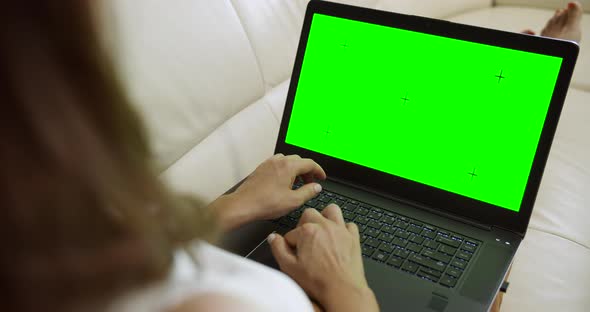 Woman with Laptop Chromakey on Sofa