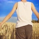 Happy Boy in a Blue Hat Walks on a Golden Wheat Field on a Sunny Day - VideoHive Item for Sale
