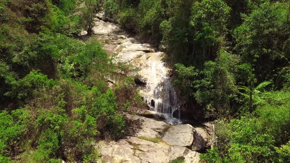 Drone Flight Over a Waterfall in the Tropical Rainforest Jungle on Summer Day alt