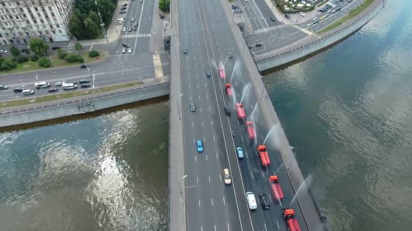 Several Special Watering Machines Lined Up in a Row Are Pouring Water on the Bridge of One of the alt