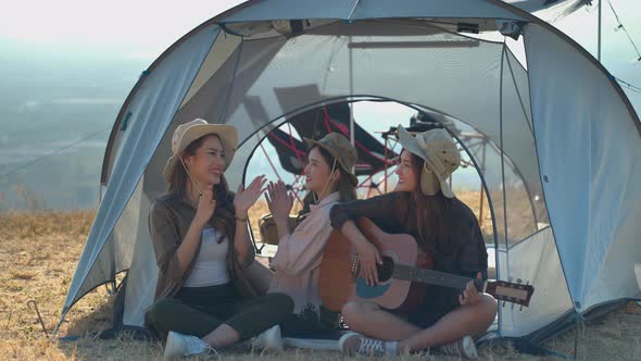Group of Asian young women having fun and enjoy music form guitar.