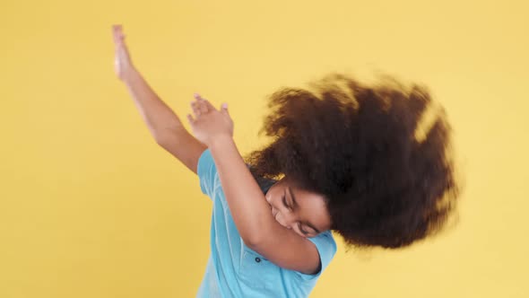 Stylish Darkskinned Multiracial Small Girl Dancing and Put Hands Up alt