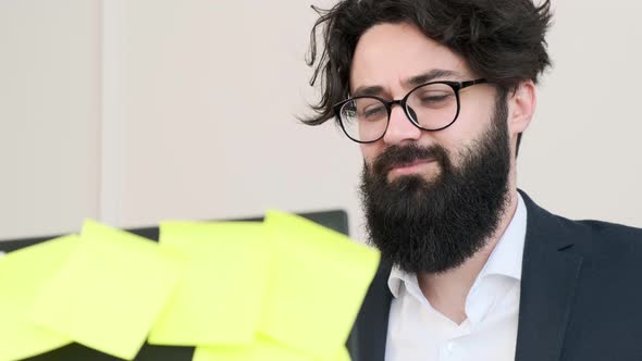 Bearded Man Comfortable at His Desk Having a Video Call Conference alt