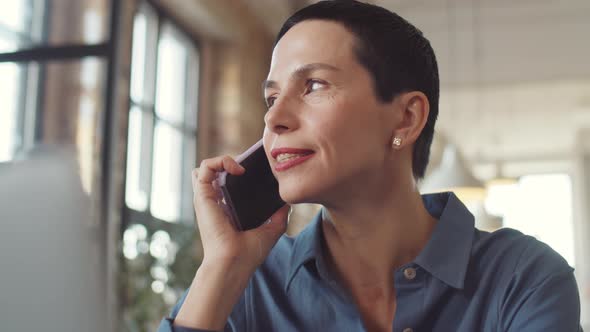 Business Lady Having Phone Conversation in Office alt