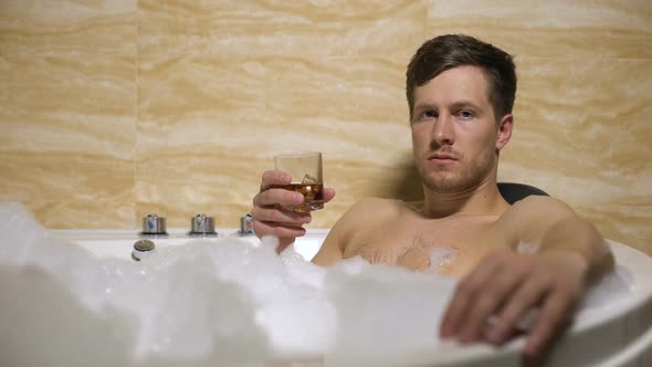 Oligarch Trying to Relax in Warm Bath, Drinking Whiskey, Thinking About Problems alt