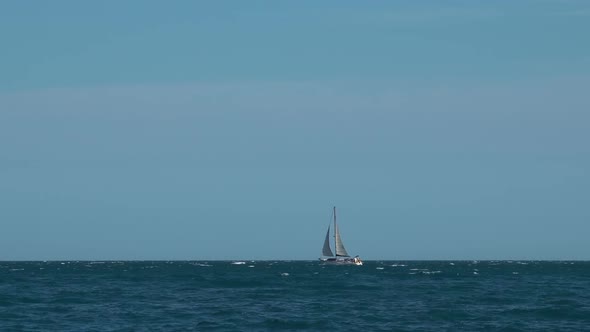 White Yacht Sails by the Sea alt