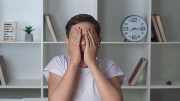 Portrait of a Frightened Child Sees the Terrible and Covers His Face with His Hands in Horror alt