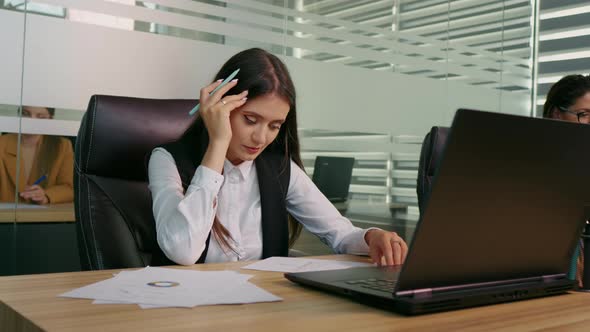 Businesswoman is overwhelmed and feels stressed out at workplace. alt