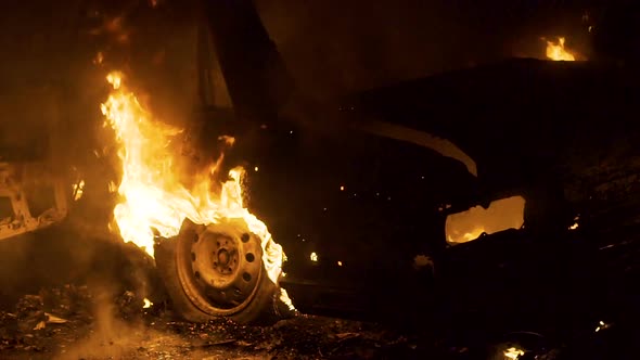 Car In Fire At Night, Burning Car Wheel, Rear View