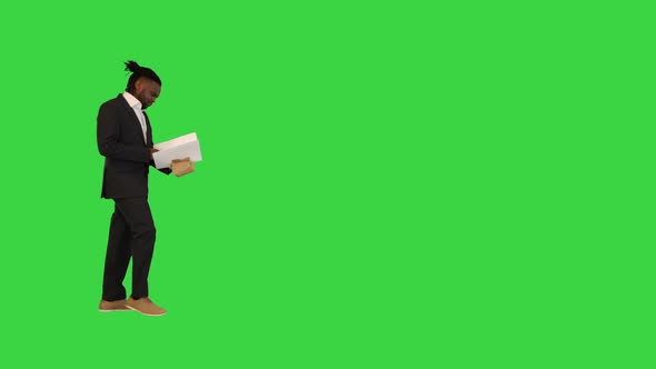 African American Man in Office Suit Walk Looking Into Document on a Green Screen Chroma Key alt