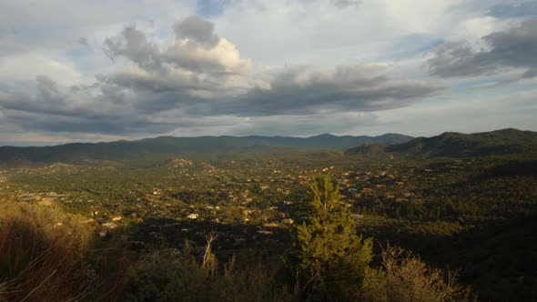 Storm clouds gather over Prescott homes in the mountains during sunset. alt
