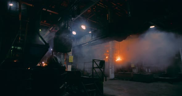 Metallurgical plant. Steam and fire in the plant, there is a melting metal.