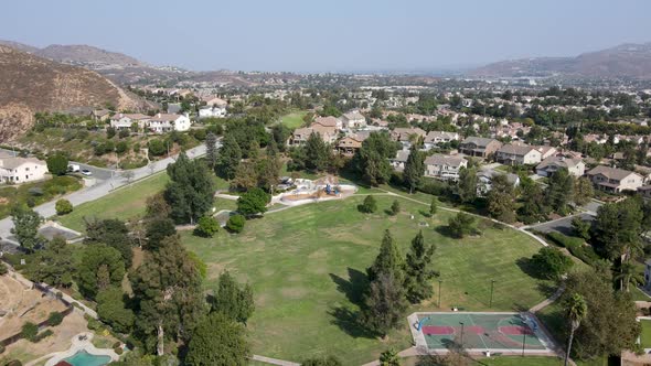 Aerial View of Villas Surrounded By Green Golf Courses in Corona Town. alt