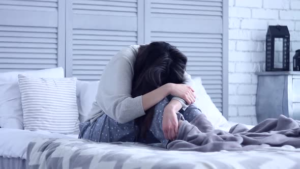 Unsuccessful Sad Woman Sitting at Grey Bedroom on Bed alt
