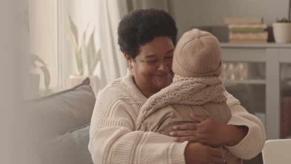 Granny Hugging Kid Coming from Walk alt