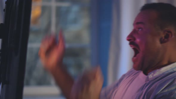 Excited Man Watching Sports on Tv and Supporting Favorite Team alt