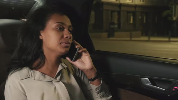 Woman Having Phone Call In Taxi alt