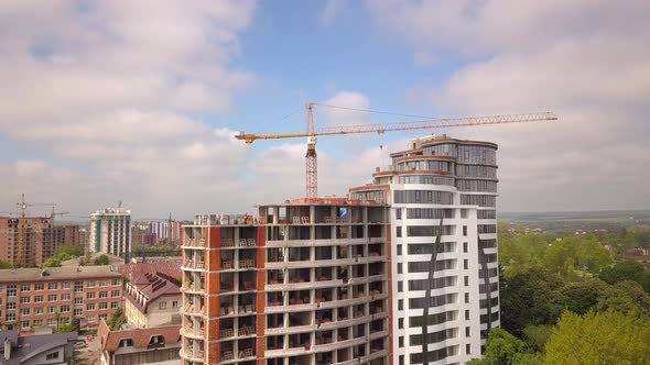 High industrial tower crane at construction site of new residential building. alt
