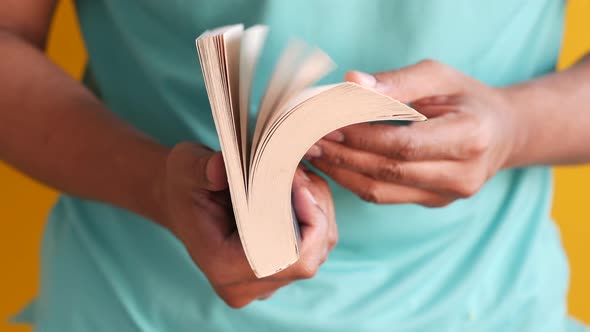 Close Up of Man's Hand Turning a Pager of a Book alt