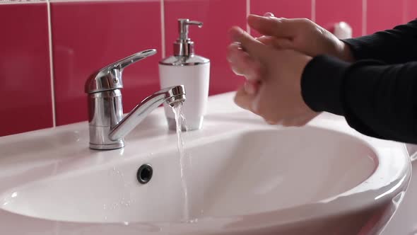 Man Washes His Hands with Soap alt