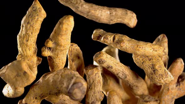 Turmeric Curcuma Longa Root Falling on Curcuma Powder Indian Spice Slow Motion alt