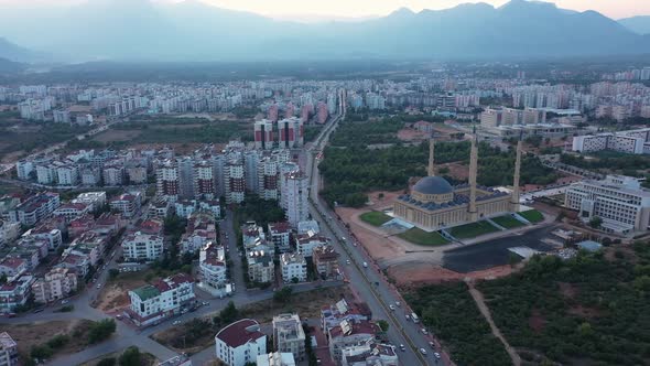 Modern City Panorama with View of Mosque Minaret and Mountains alt