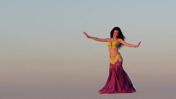 Brunette Dances Belly Dancing in the Sandy Desert, Her Movements Are Unique alt
