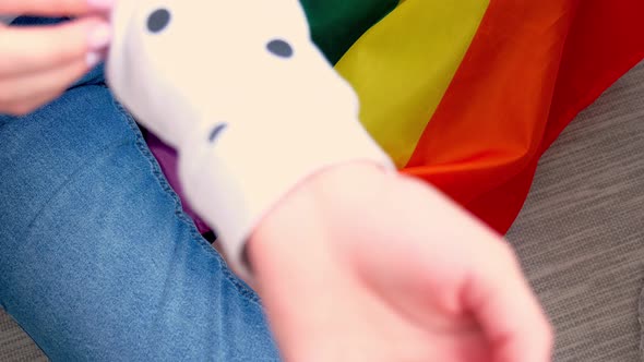Closeup of Young Caucasian Millennial Hippie Woman Showing Rainbow Flag in Heart Shape Painted in alt