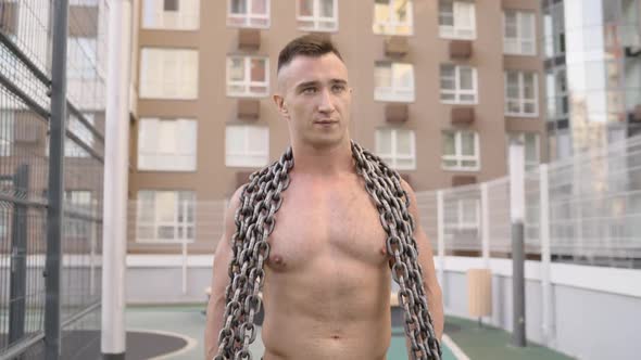 Shirtless Young Man Holding a Chain alt