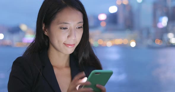 Business woman use of smart phone at night  alt