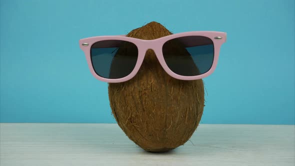 Coconut in Sunglasses and a Cap Symbolizing a Summer Vacation. Stop Motion Animation alt