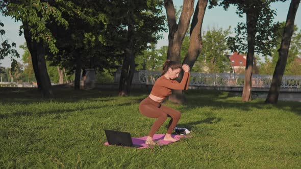 Woman is training in park at morning