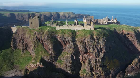 beautiful scenic flight level with the ruins of the once mighty  dunnottar castle in scotland shows alt