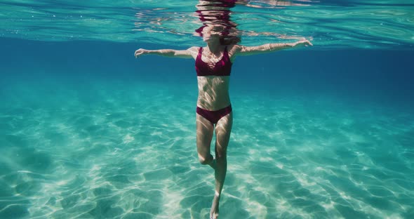 Beautiful woman swimming in underwater paradise alt