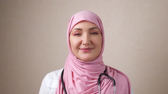 Woman Doctor in Hijab with Phonendoscope on Neck Smiling Looking at Camera alt