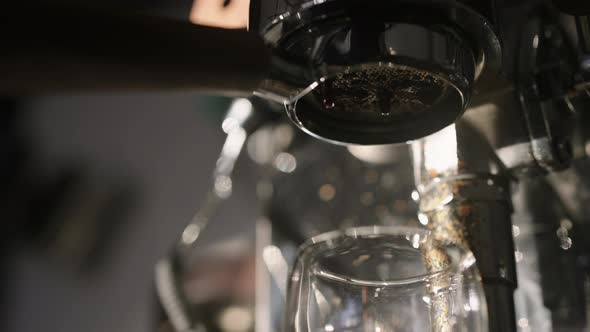 Slow Motion Pour Espresso with Bottomless Portafilter Into Glass Cup with Morning Light alt