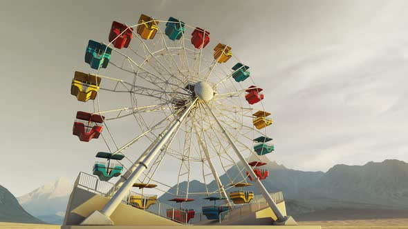 Big, colorful Ferris wheel spinning slowly in a mountain landscape during sunset